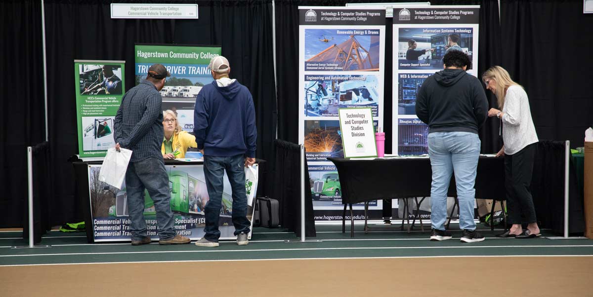 Visitors looking at the different booths setup for the HCC Open House
