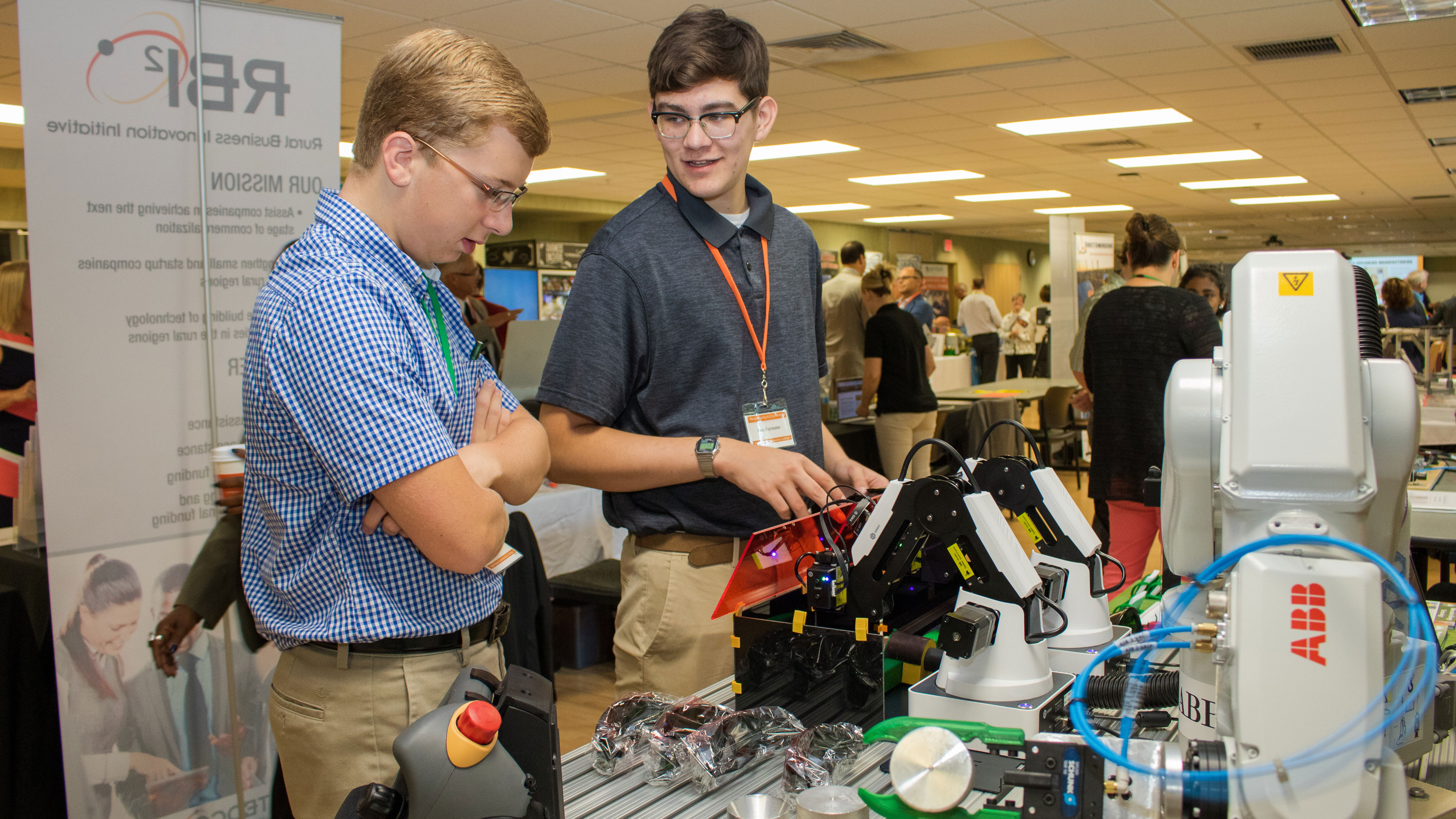 Two students operating mechanical robot