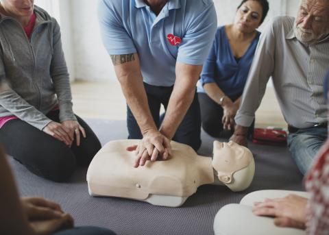 man demonstrating CPR for students