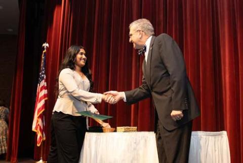 A WSCE graduate receiving their certificate from HCC President Dr. Klauber