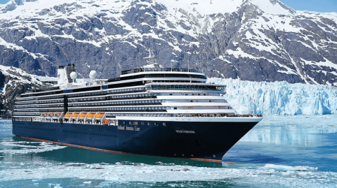 Holland America's ship Noordam sailing along the Alaskan coastline with glaciers in the background